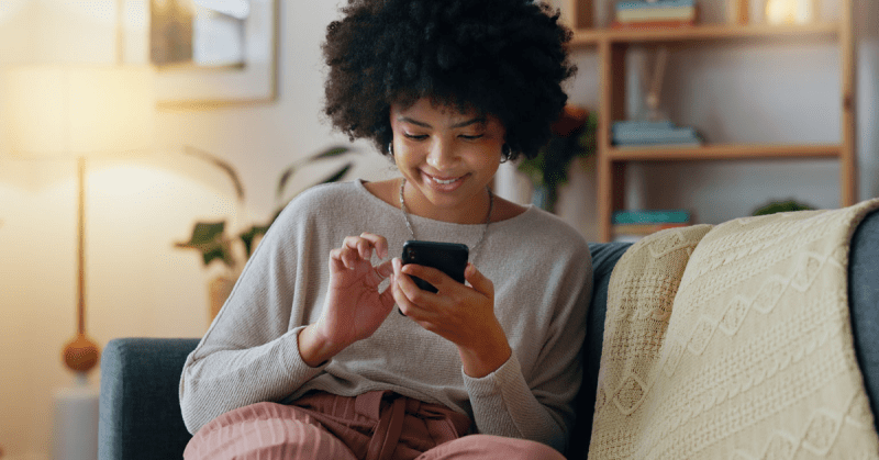 a woman uses a mobile phone to make a donation to a nonprofit